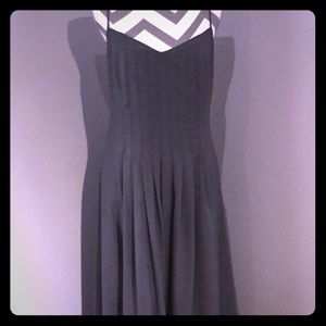 Tea length sleeveless dress with pockets.
